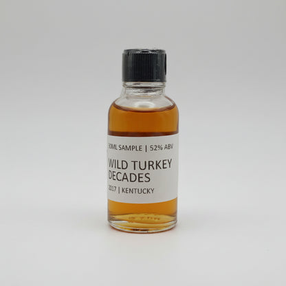 Small bottle of Wild Turkey Decades whiskey on a white background