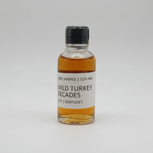 Small bottle of Wild Turkey Decades whiskey on a white background