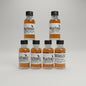 Collection of Wild Turkey bourbon bottles on a bar counter with a blurred bar background.