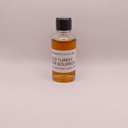 Small bottle of Wild Turkey bourbon on a light gray background