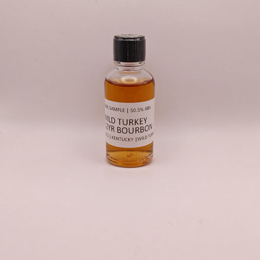 Small bottle of Wild Turkey bourbon on a light gray background