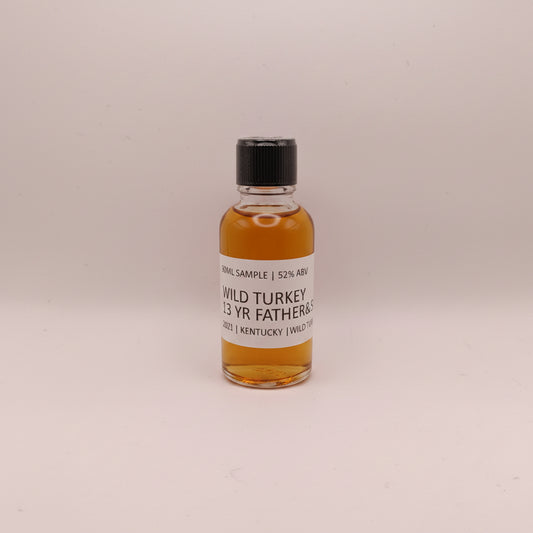 Small bottle of Wild Turkey whiskey on a light gray background