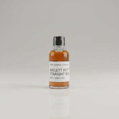 Bottle of Willett Pot Still Straight Bourbon on a reflective surface with blurred background