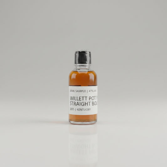 Bottle of Willett Pot Still Straight Bourbon on a reflective surface with blurred background