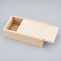 A light natural wood sliding box with a hinged lid, shown open on a neutral gray background.