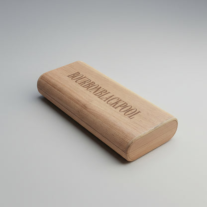 Wooden cigar case with 'Bourbon Blackpool' engraving on a wooden surface