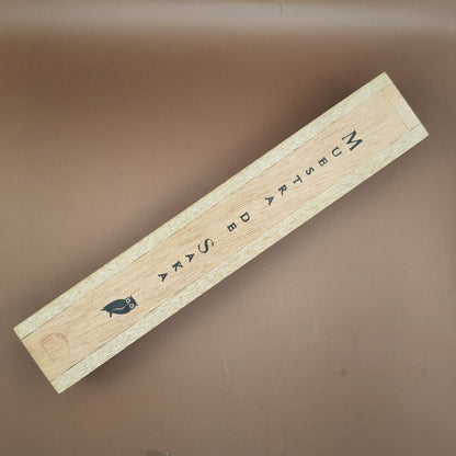 Wooden box with text and a bird illustration on a brown background
