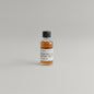Small bottle of Woodford Reserve bourbon on a beige background