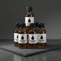 Bottles of Oak Drop Collection whiskey samples on a gray background
