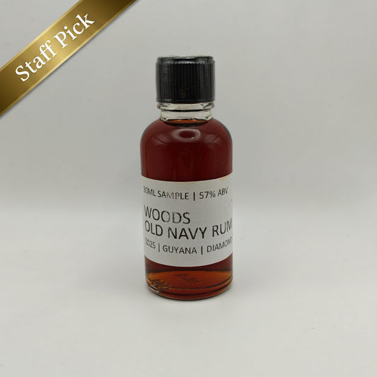 Small bottle of Woods Old Navy Rum on a light gray background