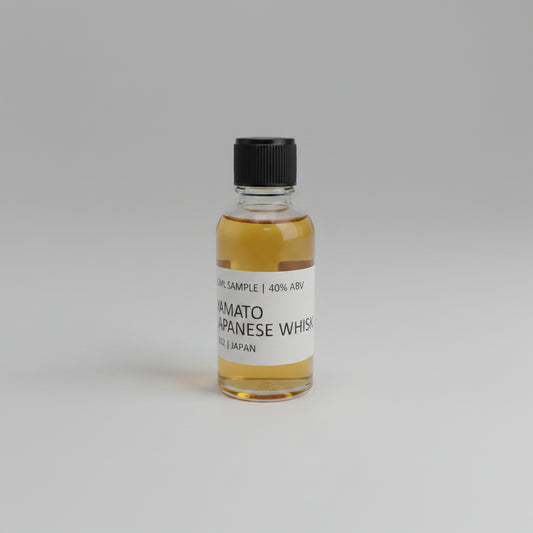 Small bottle of Yamato Japanese Whisky sample on a light gray background