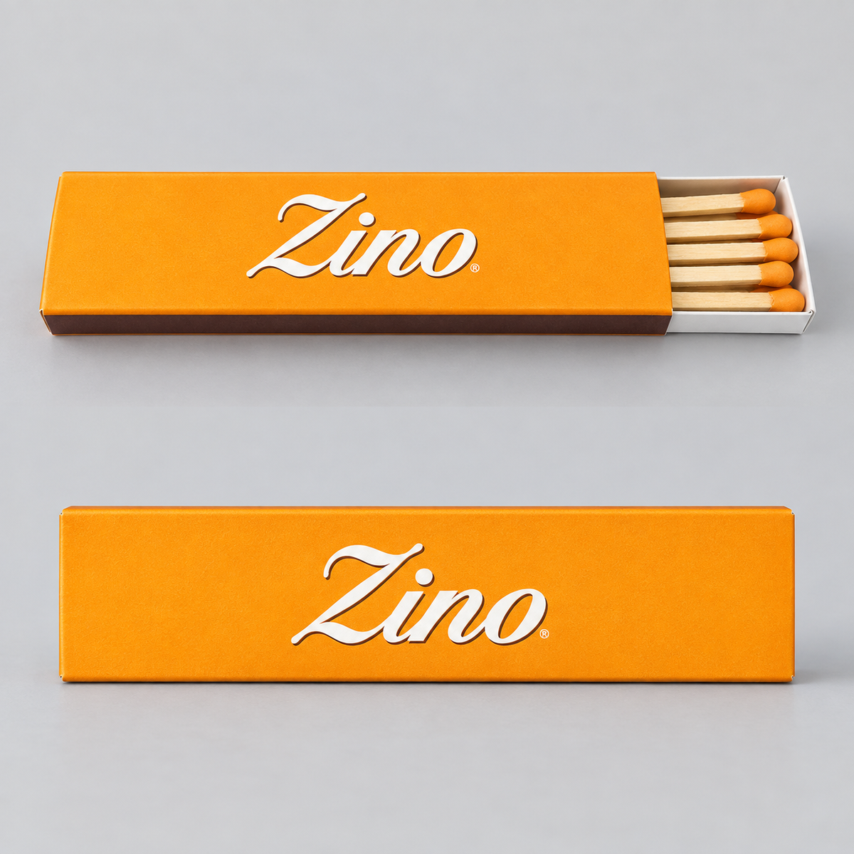 Two orange Zino matchboxes on a light gray background, one closed and one open showing wooden matches with orange tips. The brand name 'Zino' is printed in white script on the front of both boxes.