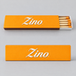 Two orange Zino matchboxes on a light gray background, one closed and one open showing wooden matches with orange tips. The brand name 'Zino' is printed in white script on the front of both boxes.