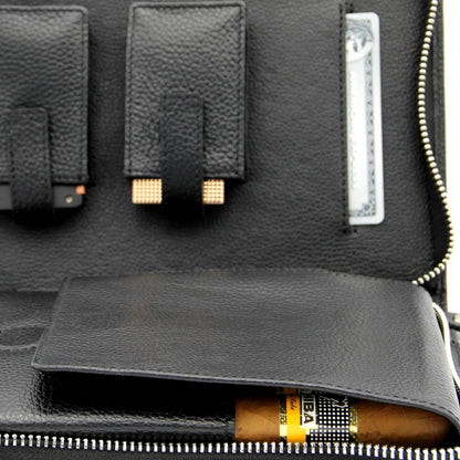 Black leather wallet with a zipper, featuring a visible brand label, on a dark background.