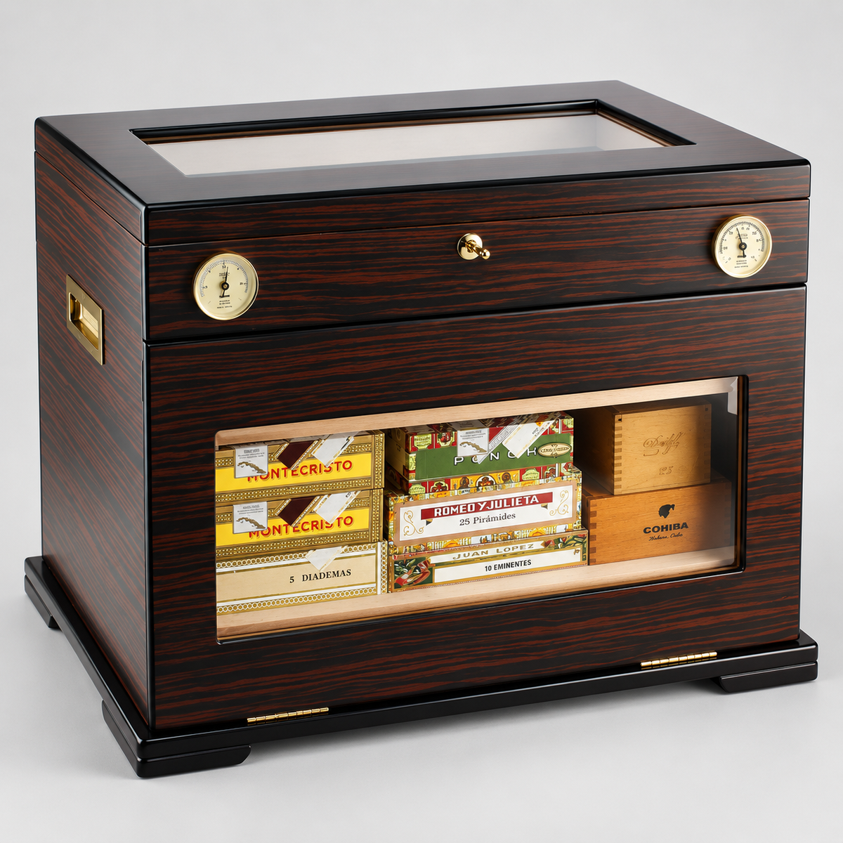 A dark wood cigar humidor and storage cabinet with a glass top, front drawer, brass dials, and a glass-front lower compartment displaying various cigar boxes. The cabinet is photographed on a neutral light gray studio background.