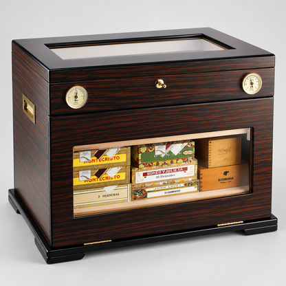 A dark wood cigar humidor and storage cabinet with a glass top, front drawer, brass dials, and a glass-front lower compartment displaying various cigar boxes. The cabinet is photographed on a neutral light gray studio background.