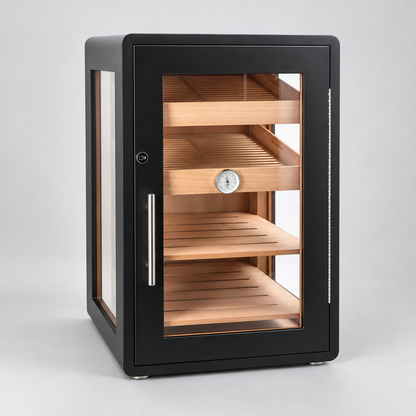 A modern humidor cabinet with a matte black metal frame, clear glass door, and natural wood interior shelves with a central temperature gauge.
