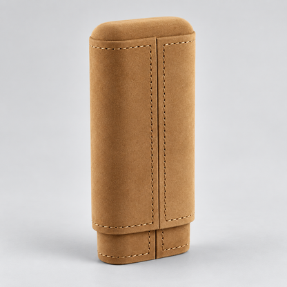 A tan suede or nubuck leather cigar case with contrast stitching, shown standing upright on a light gray background.