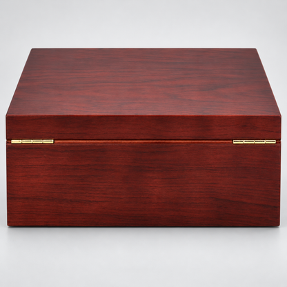 A rectangular wooden storage box with a reddish-brown wood grain finish and gold-tone metal hinges, photographed on a light gray background.