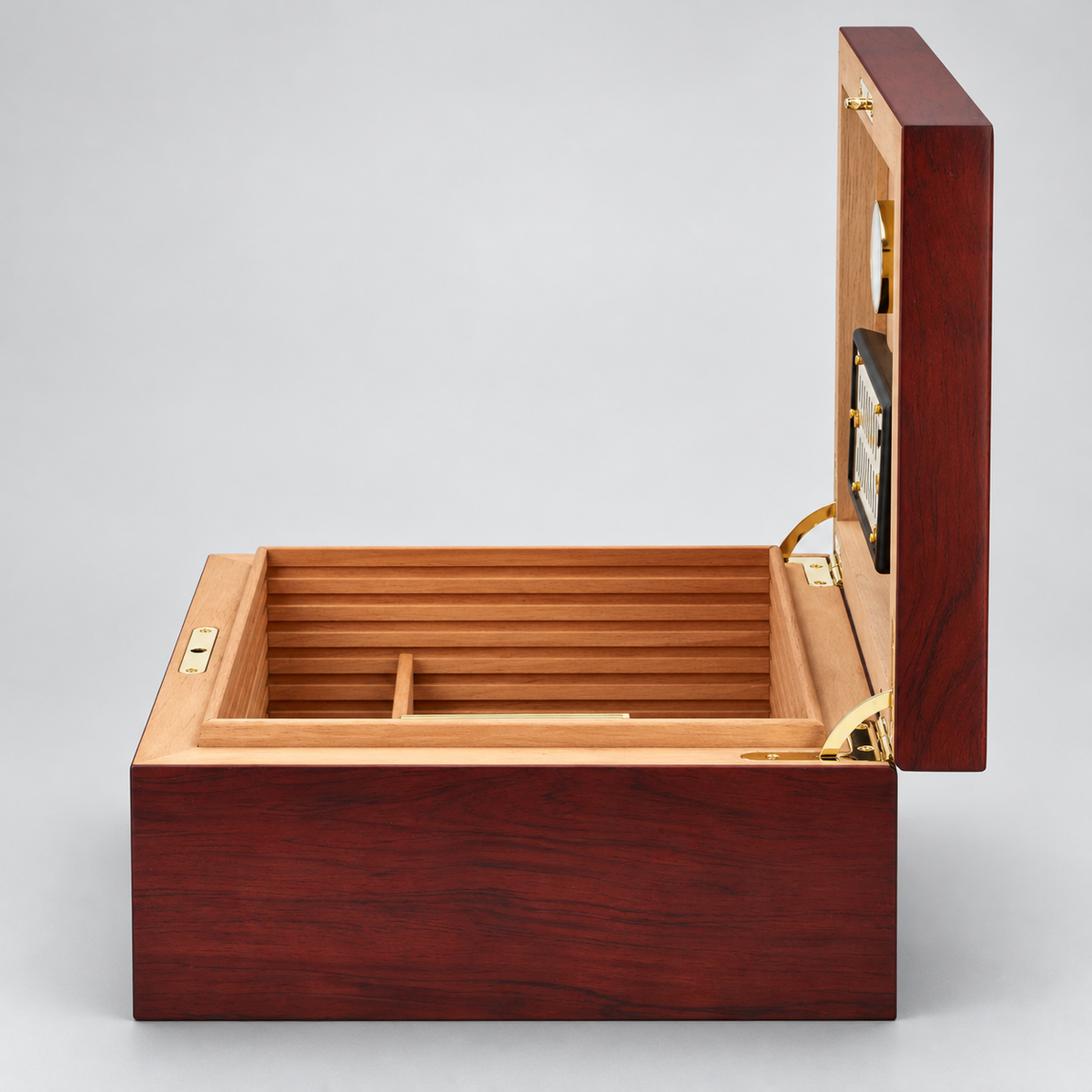 A premium wooden cigar humidor box with a dark reddish-brown mahogany exterior, light natural wood interior, and brass hardware, shown open on a light gray background.