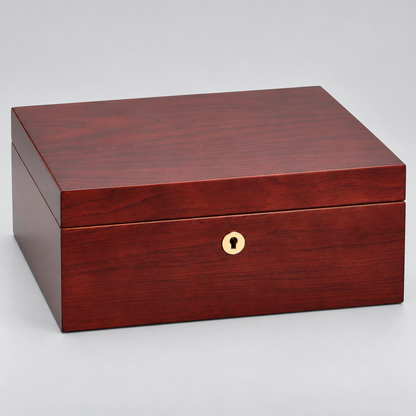 A rectangular wooden storage box with a glossy reddish-brown wood grain finish and a small round gold-tone keyhole detail on the front, photographed on a light gray studio background.