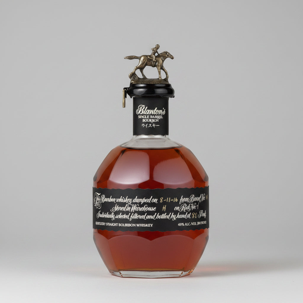 A bottle of Blanton's Single Barrel Bourbon Whiskey with a black label and a silver horse-and-rider cap, shown against a neutral gray background.