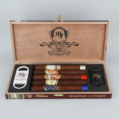 Open wooden cigar presentation box labeled 'My Father Selection' containing five cigars, a white cigar cutter, and a black lighter, all branded with the My Father logo.