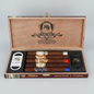Open wooden cigar presentation box labeled 'My Father Selection' containing five cigars, a white cigar cutter, and a black lighter, all branded with the My Father logo.