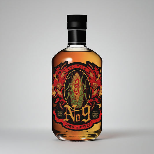 A bottle of Iowa Whiskey No. 9 Red Case whiskey with a black cap and a detailed label featuring red, gold, and green corn illustrations.
