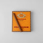 A single brown cigar resting diagonally across an orange Partagas Club 20 cigar box on a light gray background.