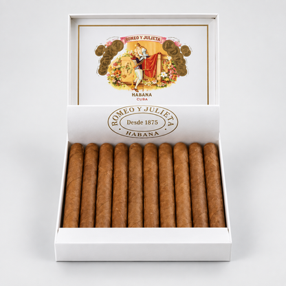 An open white cigar box displaying multiple brown cigars inside, with the branded lid open behind them on a clean light gray background. The box is labeled Romeo y Julieta Habana.