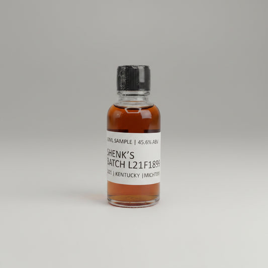 Small bottle with a label OF sHENKS BATCH l21f1899 on a light gray background