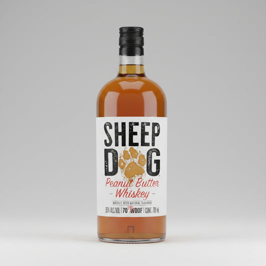 A bottle of Sheep Dog Peanut Butter Whiskey with a white label featuring a dog paw print and bold black and red lettering, filled with amber-colored liquor and topped with a black cap.