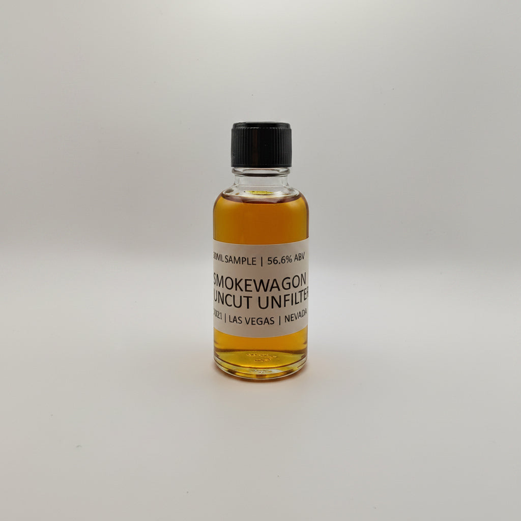Small bottle of Smokewagon Whiskey on a white surface with a gray textured background
