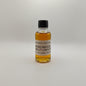 Small bottle of Smokewagon Whiskey on a white surface with a gray textured background