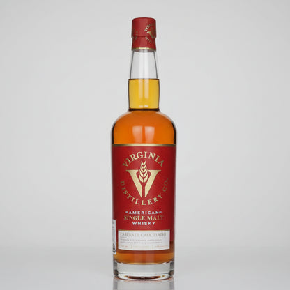A bottle of Virginia Distillery Co. American Single Malt Whisky, 1950, featuring a red label with gold lettering and a red wax seal on a light gray background.
