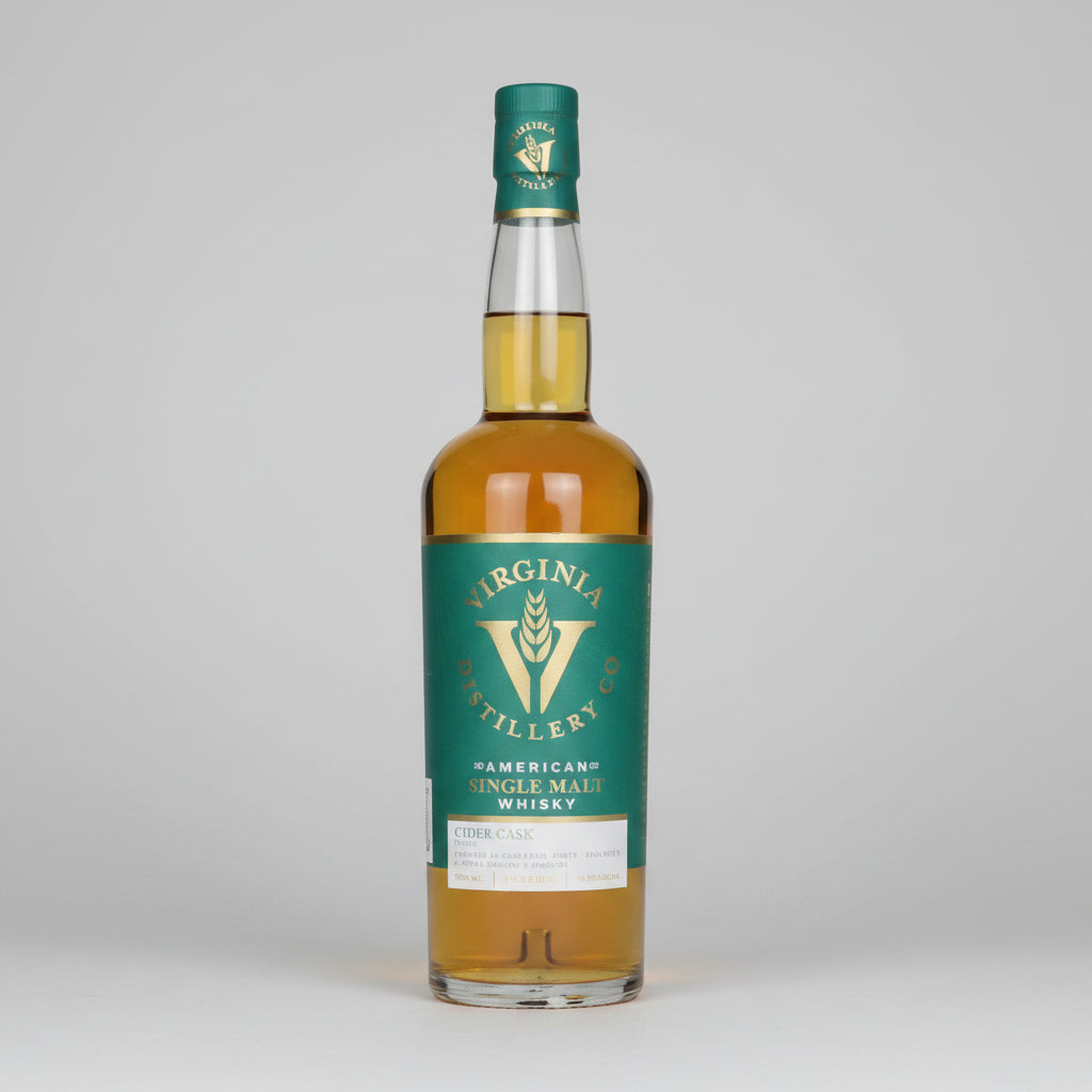 A bottle of Virginia Millery American Single Malt Whisky with a green label and gold liquid inside, shown on a white background with a reflection.