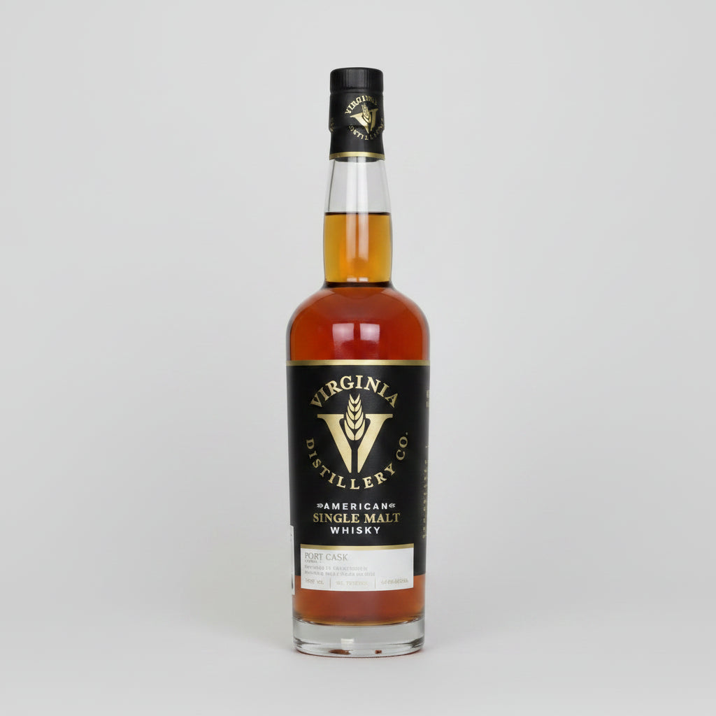 A bottle of Virginia Distillery Co. American Single Malt Whisky, featuring amber-colored liquid in a clear glass bottle with a black label and gold lettering, set against a plain white background.