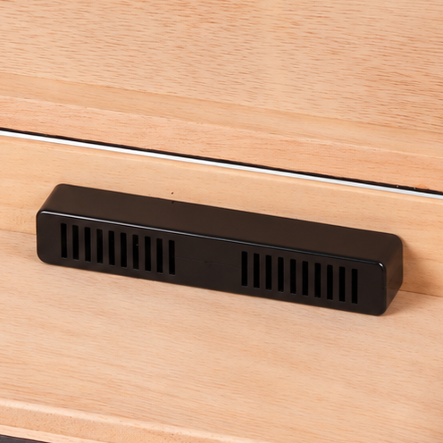 An open wooden humidor box with a light natural wood interior, dark brown wood exterior, and a small black ventilation device resting inside, shown on a light gray background.