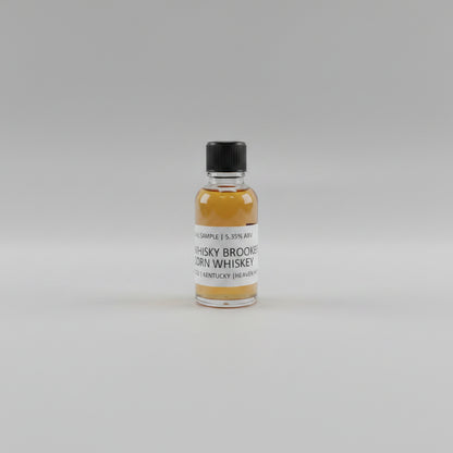 Small bottle of whisky Brooker corn whiskey with a label on a light background