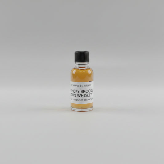 Small bottle of whisky Brooker corn whiskey with a label on a light background