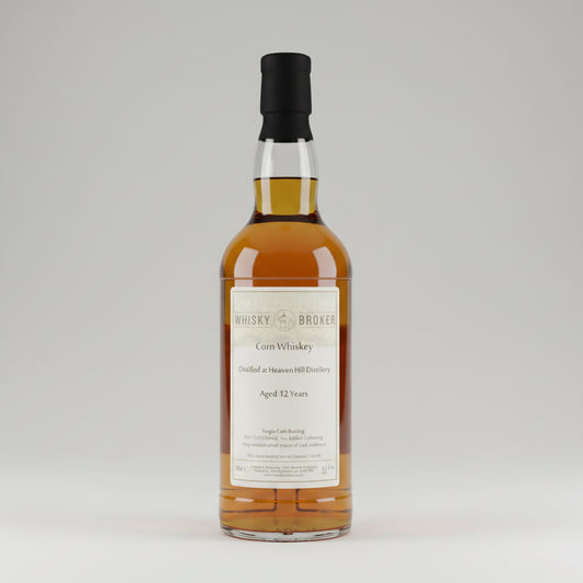 A bottle of whisky Broker with amber liquid, a cream label reading 'Whisky Broker Corn Whiskey' and 'Aged 12 Years', and a black cap, shown against a plain light background.